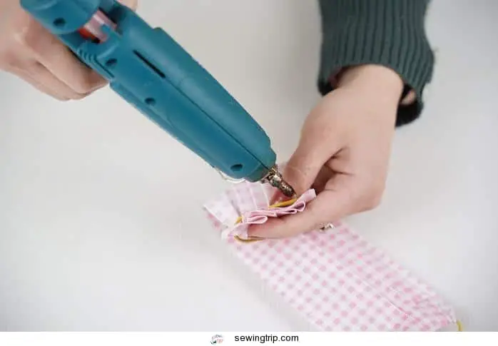 hot glue gun to secure end of the fabric