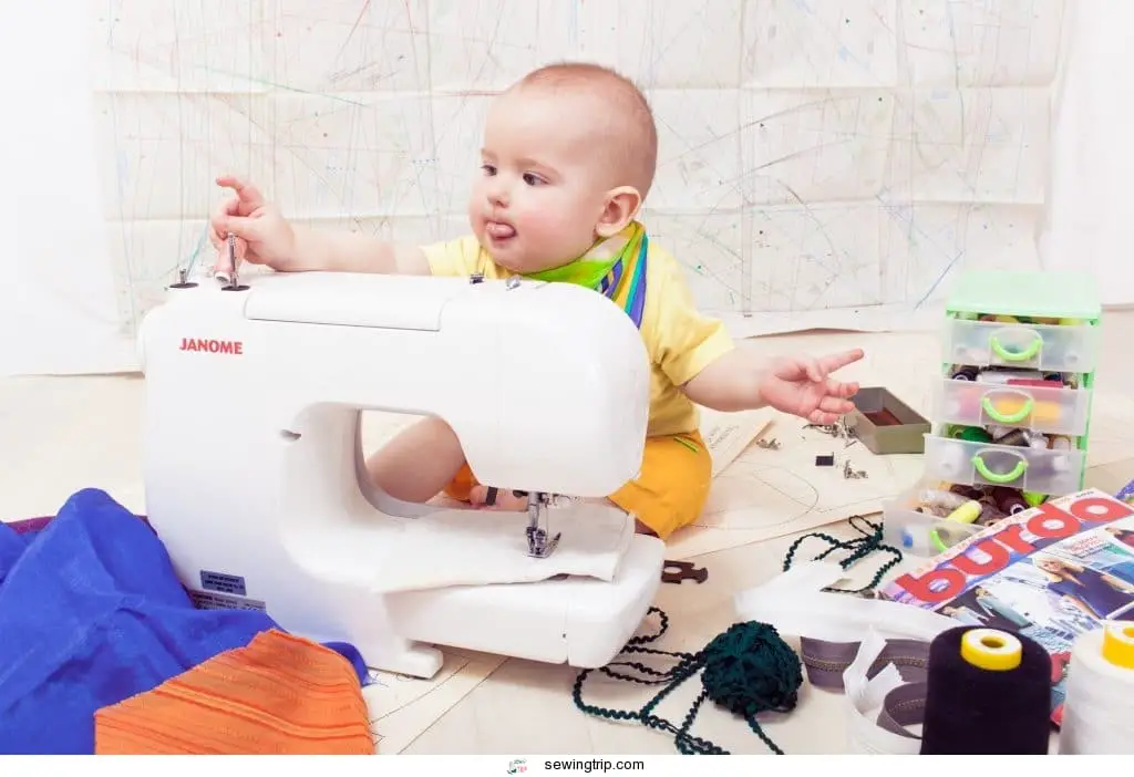 baby learning to sew on a machine