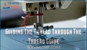 guiding the thread through the thread guide