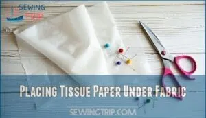 placing tissue paper under fabric