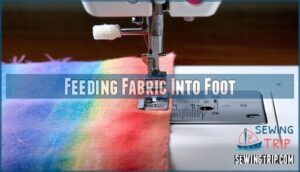 feeding fabric into foot