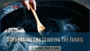 submerging and stirring the fabric