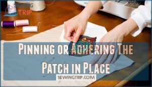 pinning or adhering the patch in place